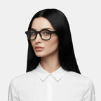 VAUCLIOR PRISM PRO smart glasses with black frames and 8MP camera, worn by a woman with black hair and a white shirt.