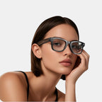 VAUCLIOR VC AXE GEN1 smart glasses with rectangular black matte frame and clear lenses, worn by a woman.