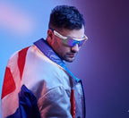 VAUCLIOR VC TITAN-SL white smart glasses with iridescent lenses worn by a man in a colorful jacket.